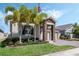 Charming single-Gathering home with stone accents, manicured lawn, and lush palm trees at 1807 Good Neighbor Loop, Kissimmee, FL 34744