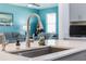 Modern kitchen island with stainless steel sink and faucet, with a view to the adjacent living room at 1807 Good Neighbor Loop, Kissimmee, FL 34744