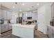 This modern kitchen features stainless steel appliances, gray cabinetry, a kitchen island, and stylish pendant lighting at 1807 Good Neighbor Loop, Kissimmee, FL 34744