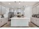This modern kitchen features stainless steel appliances, gray cabinetry, a kitchen island, and stylish pendant lighting at 1807 Good Neighbor Loop, Kissimmee, FL 34744