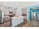 This modern kitchen features stainless steel appliances, gray cabinetry, a kitchen island, and stylish pendant lighting at 1807 Good Neighbor Loop, Kissimmee, FL 34744