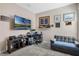 Spacious living area featuring a comfortable couch, TV, and a dedicated workspace at 1807 Good Neighbor Loop, Kissimmee, FL 34744