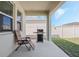 Covered patio with seating and a grill, perfect for outdoor entertaining at 1807 Good Neighbor Loop, Kissimmee, FL 34744