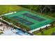 Aerial view of the community featuring two tennis courts with green surfaces, surrounded by greenery at 1807 Good Neighbor Loop, Kissimmee, FL 34744