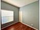 Clean, well-lit bedroom featuring hardwood flooring, a window with blinds, and a closet at 2014 Applegate Dr, Ocoee, FL 34761