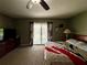Spacious bedroom featuring an outdoor balcony, fan and carpeted floors at 2014 Applegate Dr, Ocoee, FL 34761