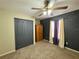 Bedroom featuring carpet flooring, ample closet space, and lots of natural light at 2014 Applegate Dr, Ocoee, FL 34761
