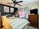 Bedroom featuring a dark accent wall, cozy decor and lots of natural light at 2014 Applegate Dr, Ocoee, FL 34761