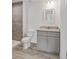 Bathroom featuring a gray vanity with granite counters, vinyl flooring, and tiled shower at 20661 Sw Marine Blvd, Dunnellon, FL 34431