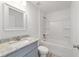 Bathroom featuring gray cabinets, granite countertop, mirror, toilet, and tub with shower head at 20661 Sw Marine Blvd, Dunnellon, FL 34431