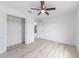 A bedroom with wood-look floors, a ceiling fan, and a closet with double doors for ample storage at 20661 Sw Marine Blvd, Dunnellon, FL 34431