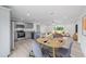 Open floor plan with sleek floors, light gray kitchen, and dining area at 20661 Sw Marine Blvd, Dunnellon, FL 34431