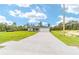 Well-maintained home featuring a long driveway, lush green lawn, and attached garage at 20661 Sw Marine Blvd, Dunnellon, FL 34431