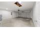 Spacious garage with a modern door, concrete floor, and natural light from the skylight at 20661 Sw Marine Blvd, Dunnellon, FL 34431