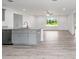Open kitchen with granite countertops, gray cabinets, stainless appliances, and LVP flooring at 20661 Sw Marine Blvd, Dunnellon, FL 34431