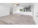 Open-concept living room with vinyl plank floors, white walls, ceiling fan and modern kitchen at 20661 Sw Marine Blvd, Dunnellon, FL 34431
