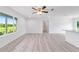 Bright living room featuring sleek vinyl floors, white walls and window with greenery views at 20661 Sw Marine Blvd, Dunnellon, FL 34431