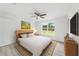 Cozy main bedroom featuring a ceiling fan, luxury vinyl plank floors, and natural light from window at 20661 Sw Marine Blvd, Dunnellon, FL 34431