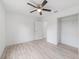 Bedroom featuring wood-look floors, closet, and a white door to the hallway at 21145 Sw Great Lakes Blvd, Dunnellon, FL 34431