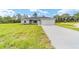 Single-story home with well-manicured lawn and two-car garage at 21145 Sw Great Lakes Blvd, Dunnellon, FL 34431