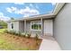 Charming covered entrance to the single-story home with manicured landscaping at 21145 Sw Great Lakes Blvd, Dunnellon, FL 34431