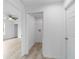 Hallway view to the living room, storage space and closed doors at 21145 Sw Great Lakes Blvd, Dunnellon, FL 34431
