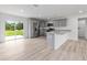 Open kitchen featuring gray cabinets, stainless steel appliances and sliding glass door at 21145 Sw Great Lakes Blvd, Dunnellon, FL 34431