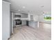 Bright, open-concept kitchen featuring gray cabinets and stainless steel appliances at 21145 Sw Great Lakes Blvd, Dunnellon, FL 34431