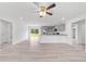 Spacious open floor plan with modern kitchen, gray cabinets, stainless steel appliances, and light wood flooring at 21145 Sw Great Lakes Blvd, Dunnellon, FL 34431