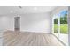Living room features a sliding glass door with outside view and vinyl plank flooring at 21145 Sw Great Lakes Blvd, Dunnellon, FL 34431