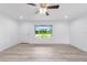 Bright living room features neutral walls, wood-look flooring, and a picturesque window view of the outdoors at 21145 Sw Great Lakes Blvd, Dunnellon, FL 34431