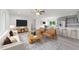 Stylishly furnished living area with a modern kitchen featuring stainless steel appliances and a cozy dining space at 21145 Sw Great Lakes Blvd, Dunnellon, FL 34431
