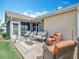 Back patio with outdoor seating, perfect for entertaining or relaxing in the sun at 2124 Westchester Way, The Villages, FL 32162