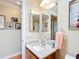 Bathroom featuring a vanity with granite countertop and a large mirror with great lighting at 2124 Westchester Way, The Villages, FL 32162