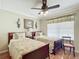 Charming bedroom featuring two twin beds, a ceiling fan and a brightly lit window at 2124 Westchester Way, The Villages, FL 32162