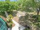Overhead view of bocce ball courts lined with lush green landscaping and tall shade trees at 2124 Westchester Way, The Villages, FL 32162
