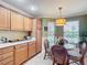 Cozy breakfast nook bathed in natural light, highlighted by a stylish pendant light and charming decor at 2124 Westchester Way, The Villages, FL 32162