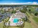 Aerial view of community pool, clubhouse and golf course in a tropical setting at 2124 Westchester Way, The Villages, FL 32162