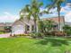 Inviting single-story home featuring lush landscaping, a two-car garage, and a well-manicured lawn at 2124 Westchester Way, The Villages, FL 32162