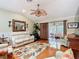 Bright living room showcasing hardwood floors, a neutral color palette, and seamless access to the sunroom at 2124 Westchester Way, The Villages, FL 32162