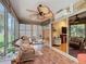 Relaxing sunroom featuring tile floors, wicker furniture, and a ceiling fan at 2124 Westchester Way, The Villages, FL 32162