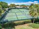 Community tennis and pickleball courts surrounded by lush green landscaping at 2124 Westchester Way, The Villages, FL 32162