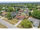 Aerial view of a home in a suburban neighborhood, showcasing its location, roof, and surrounding greenery and nearby houses at 2240 Archer Blvd, Orlando, FL 32833
