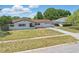 Lovely single-story home with white brick, red roof, driveway, and landscaped front yard at 2240 Archer Blvd, Orlando, FL 32833