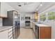 Bright kitchen featuring stainless steel appliances, sleek countertops, and ample cabinet space at 2240 Archer Blvd, Orlando, FL 32833