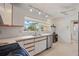 Bright kitchen featuring stainless steel dishwasher and sink with natural light from window at 2240 Archer Blvd, Orlando, FL 32833
