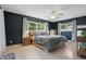 Spacious main bedroom with dark accent wall, ceiling fan, natural light, and neutral flooring at 2240 Archer Blvd, Orlando, FL 32833