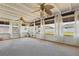 Relaxing sunroom showcasing a comfortable seating area, decorative ceiling fans, and abundant natural light at 2240 Archer Blvd, Orlando, FL 32833