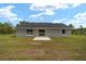 Spacious backyard with sliding glass doors and a concrete patio at 23810 Sw Indian Hill Dr, Dunnellon, FL 34431