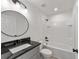 Modern bathroom features updated vanity with granite counters and a tub with tiled shower at 23810 Sw Indian Hill Dr, Dunnellon, FL 34431
